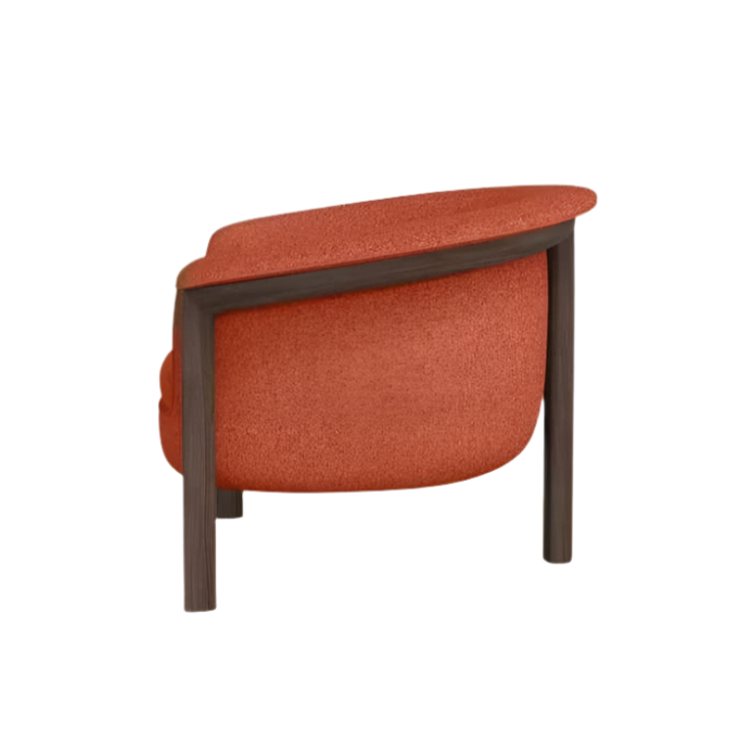 Rear three-quarter view of a modern orange fabric-upholstered accent chair with a rounded seat and curved back, supported by a dark wood frame and exposed legs.