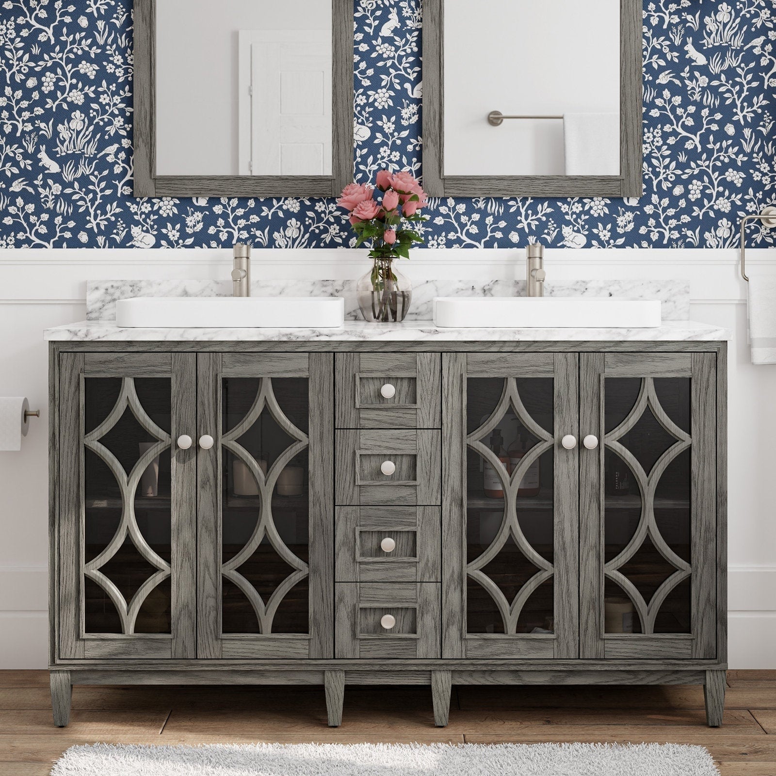 Freestanding 60-inch modern solid wood vanity in gray-stone finish with marble-look stone top, two white rectangular sinks and brushed nickel faucets, decorative glass-front doors with geometric lattice and central stacked drawers.