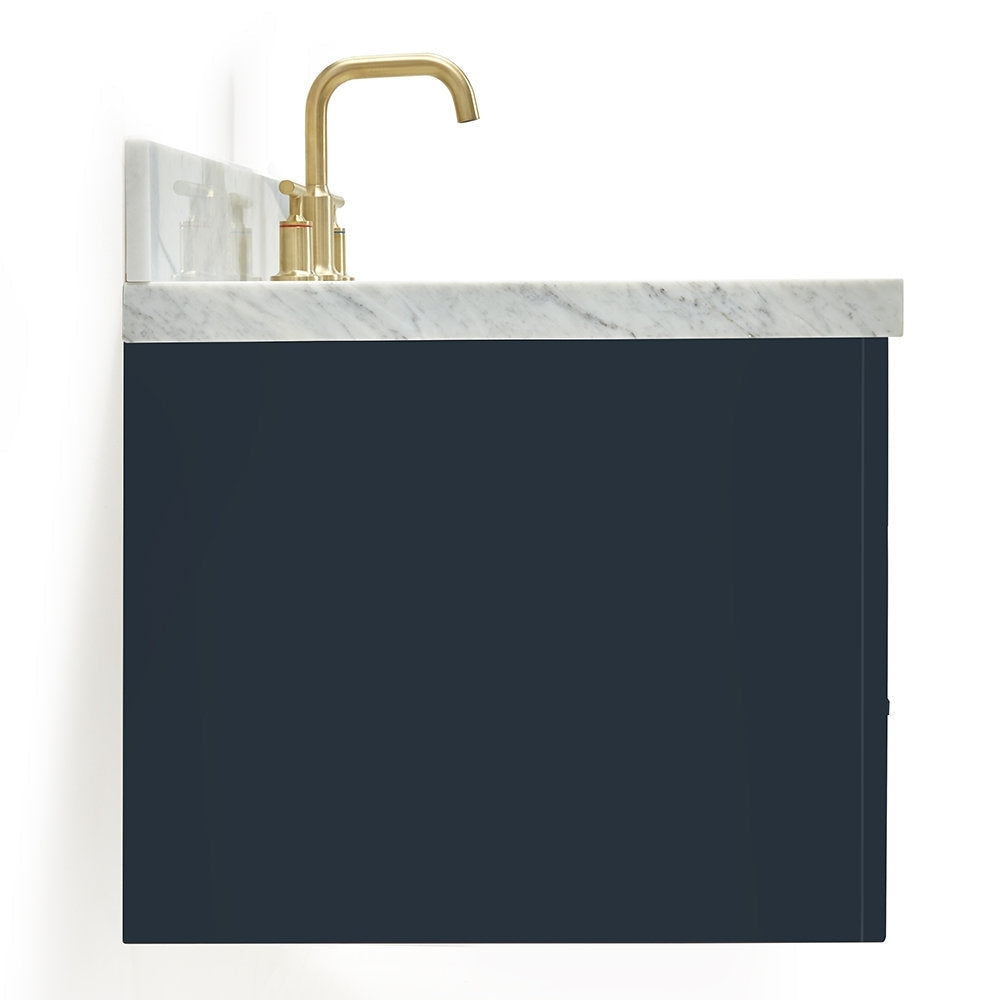 Close-up of a modern vanity featuring a white marble stone countertop, dark navy solid wood cabinet front and a brushed brass faucet with two handles.