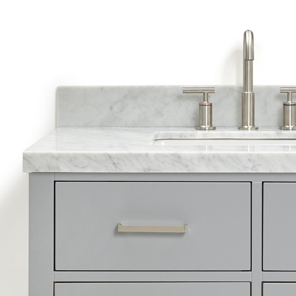 Close-up of a modern gray solid-wood bathroom vanity with a stone marble top, integrated undermount white ceramic sink, brushed-nickel three-piece faucet and matching rectangular drawer pull.