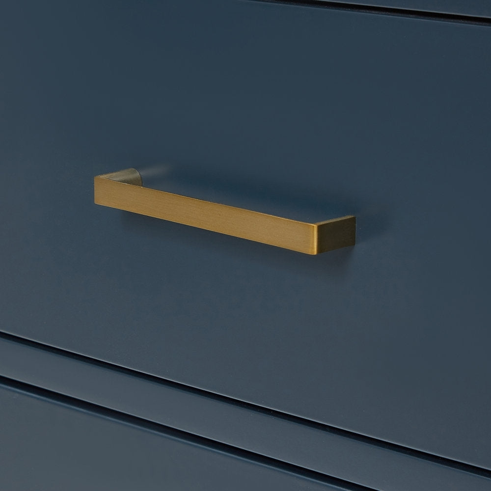 Close-up of a modern solid-wood vanity drawer in stone-gray finish featuring a rectangular brushed-gold bar handle centered on the drawer front.