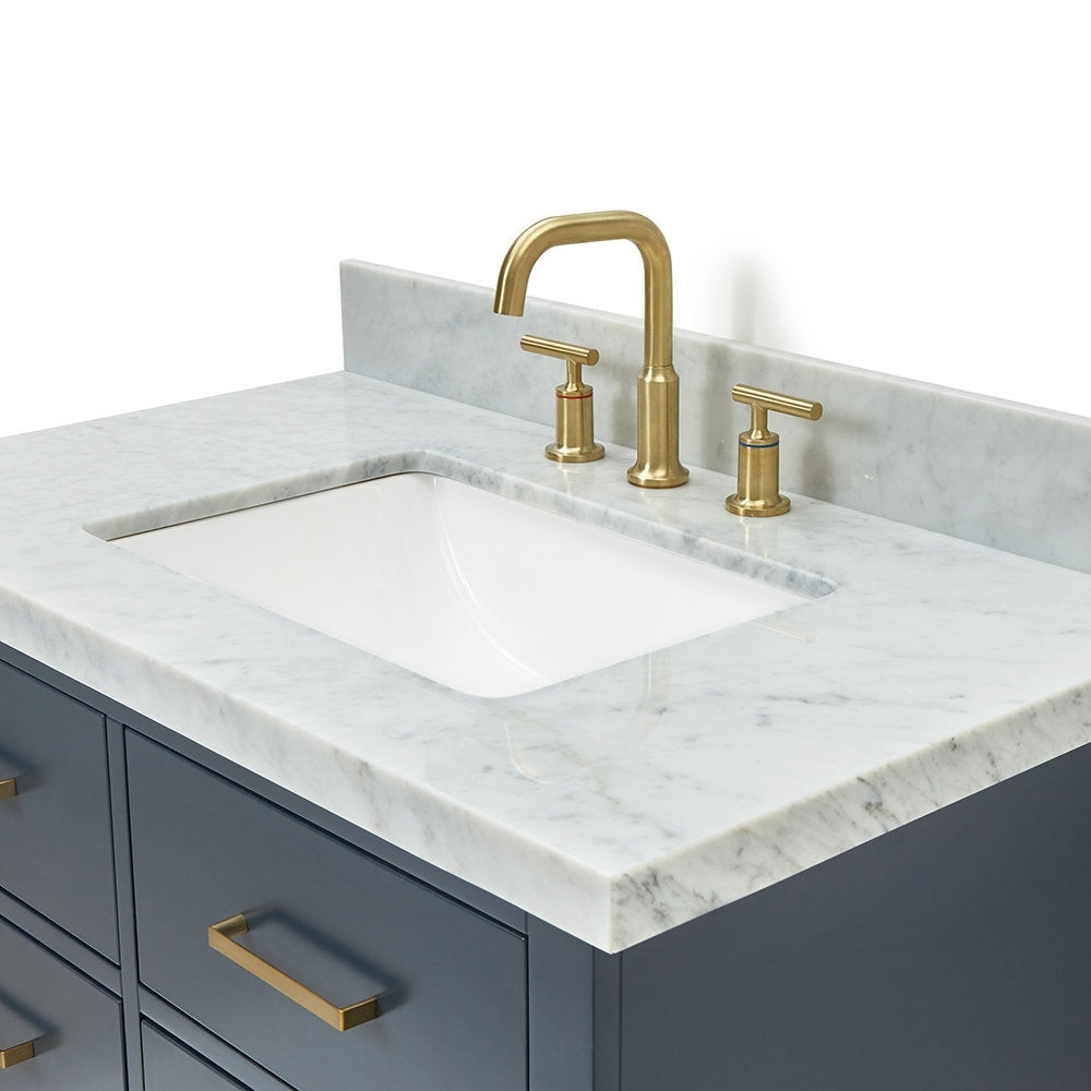 Close-up of a 37-inch stone marble top bathroom vanity featuring a white undermount rectangular ceramic sink, gray solid wood cabinet, and brushed brass faucet with matching brass drawer pulls in a modern style.