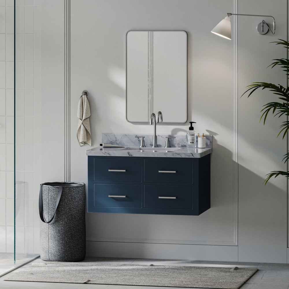 Wall-mounted 37-inch solid wood single-sink vanity with a stone marble top, deep navy painted cabinet, four drawers with metal pulls, chrome faucet, rectangular mirror and towel basket in a modern bathroom scene.