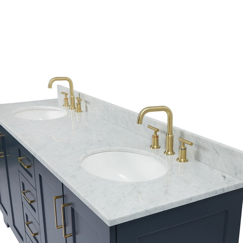 73-inch solid wood double vanity with white stone marble top and low backsplash, two undermount white ceramic sinks, satin-bronze gooseneck faucets and matching bronze bar pulls on navy-gray cabinets.
