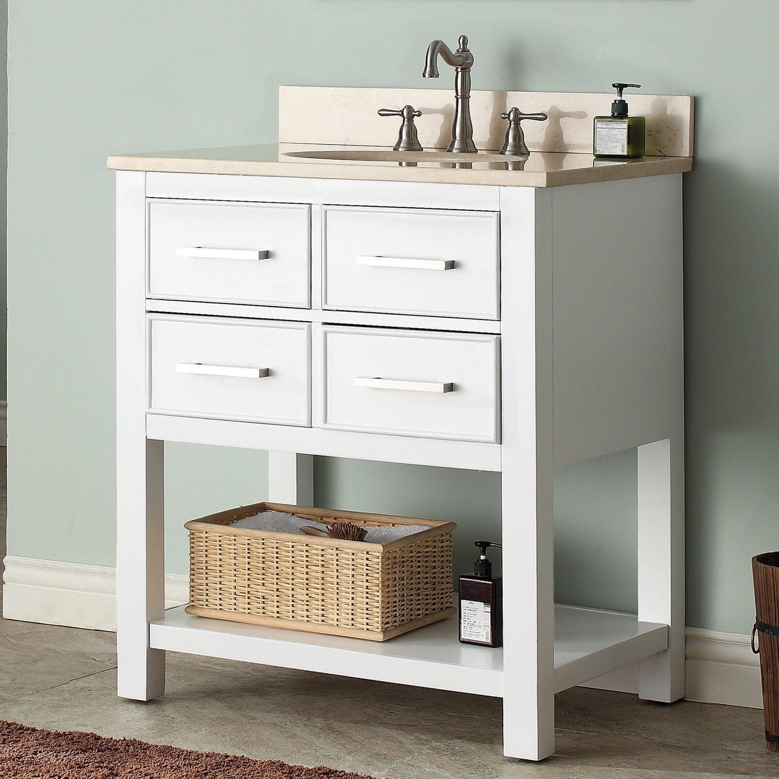 Freestanding 31-inch modern single-sink vanity in solid wood with a stone countertop and backsplash, brushed-nickel faucet, four drawer fronts, and an open lower shelf holding a wicker basket and soap dispenser.
