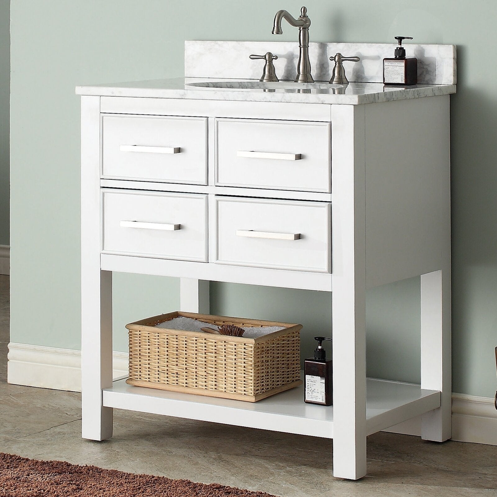 Modern freestanding solid wood bathroom vanity in stone finish with a marble-look stone top and single undermount sink, brushed metal faucet, four-drawer front and open lower shelf with woven basket and soap dispenser.