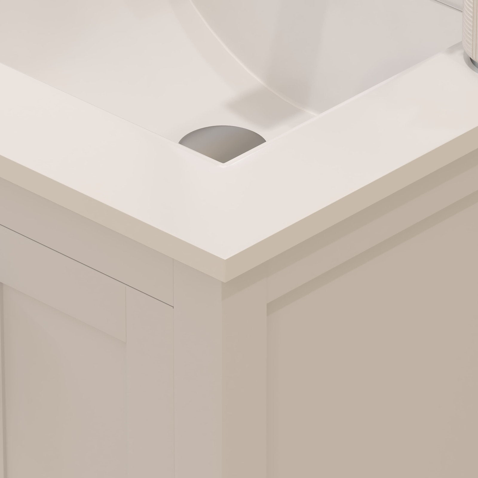 Close-up of a stone-colored top on a solid wood 24-inch modern bathroom vanity showing the integrated ceramic sink edge, drain opening and the corner of the freestanding wooden cabinet with recessed panel.