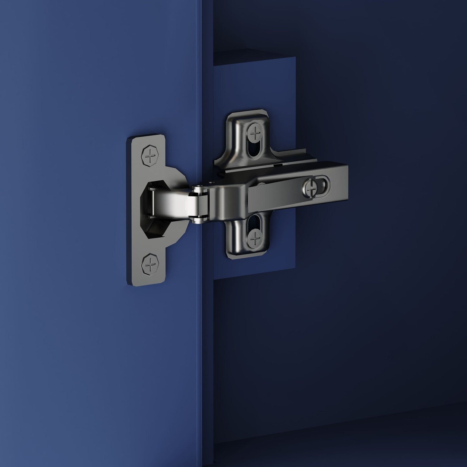 Close-up of a shiny chrome cabinet hinge mounted to a blue-painted solid wood vanity door and cabinet frame, showing metal mounting plates and visible screws inside a modern single-sink bathroom vanity.