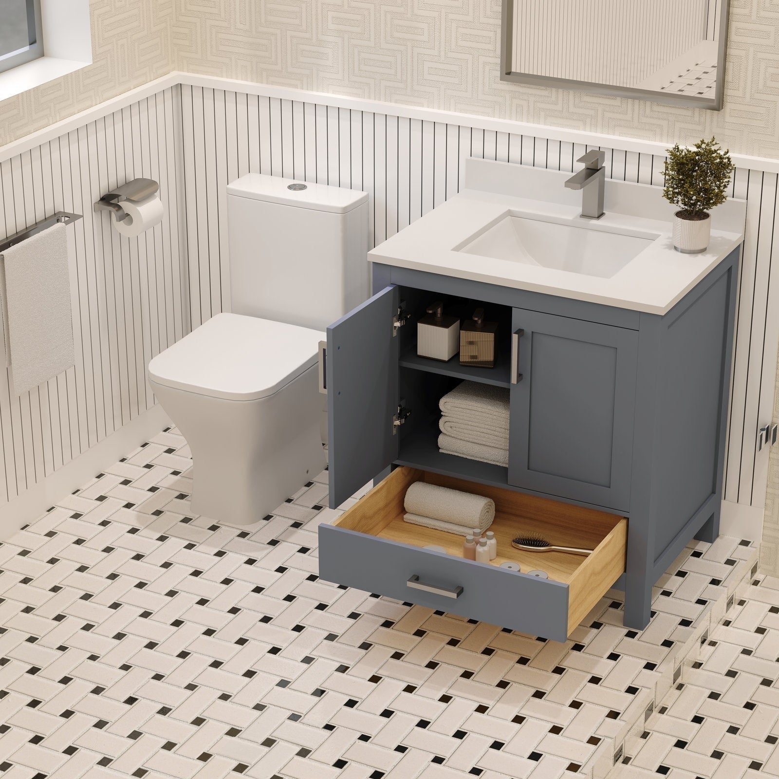 Freestanding modern solid wood vanity in blue-gray with a white stone countertop and integrated rectangular sink; open cabinet and pulled wooden drawer reveal folded towels, toiletries and a hairbrush next to a toilet on patterned tile.