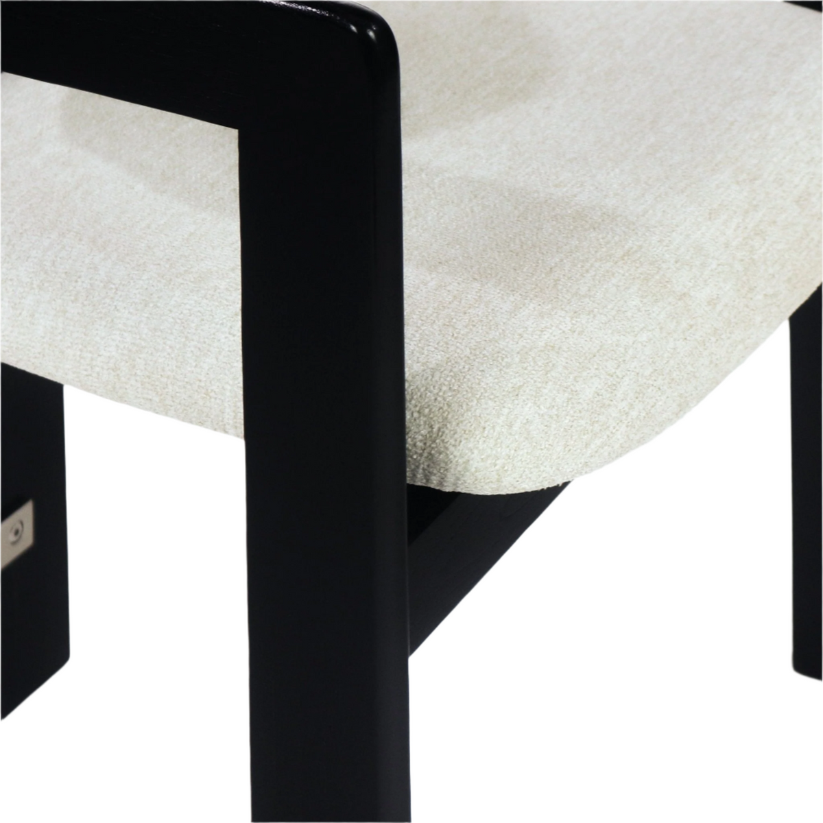 Close-up of a beige boucle upholstered dining chair seat with a curved cushioned edge and black painted frame and leg, highlighting the boucle texture and modern dining chair details.