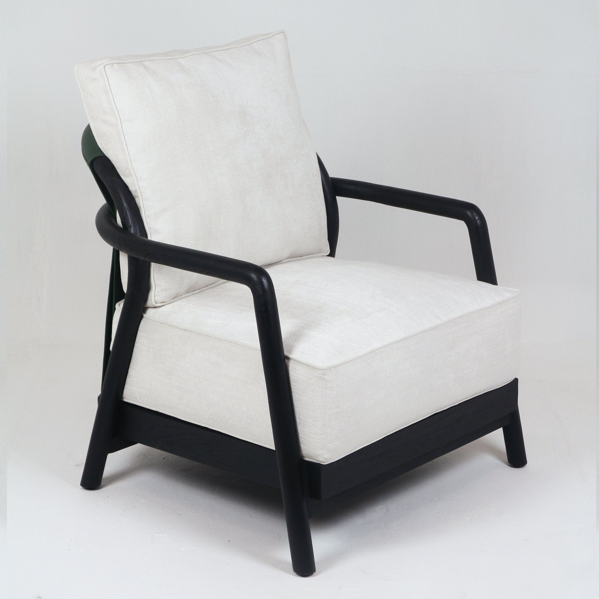 Mid-century modern armchair with a solid teak frame in a dark finish, rounded wooden armrests and tapered legs, upholstered in cream fabric with a thick boxed seat cushion and a loose back pillow.