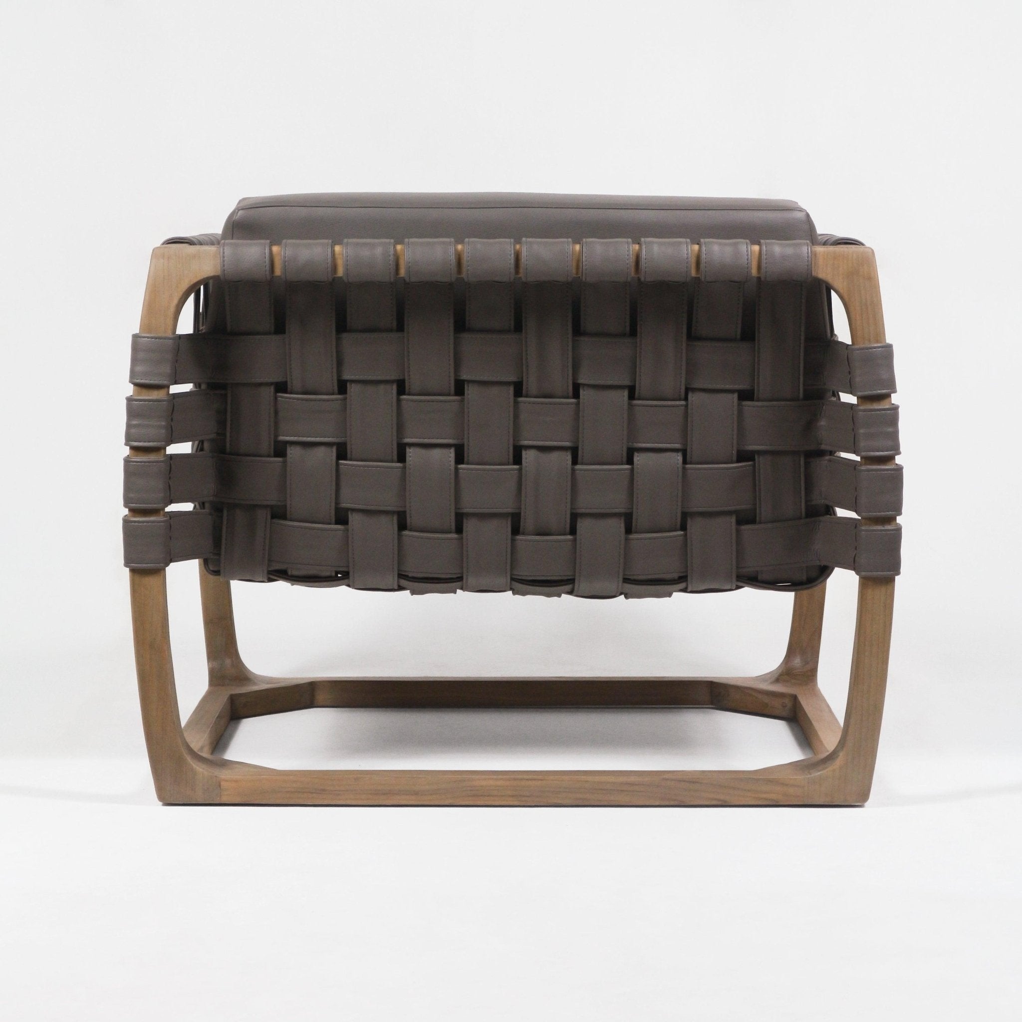 Back view of a modern lounge chair with dark brown webbed leather straps woven in a basket pattern and a light natural solid wood frame, shown on a plain white background.