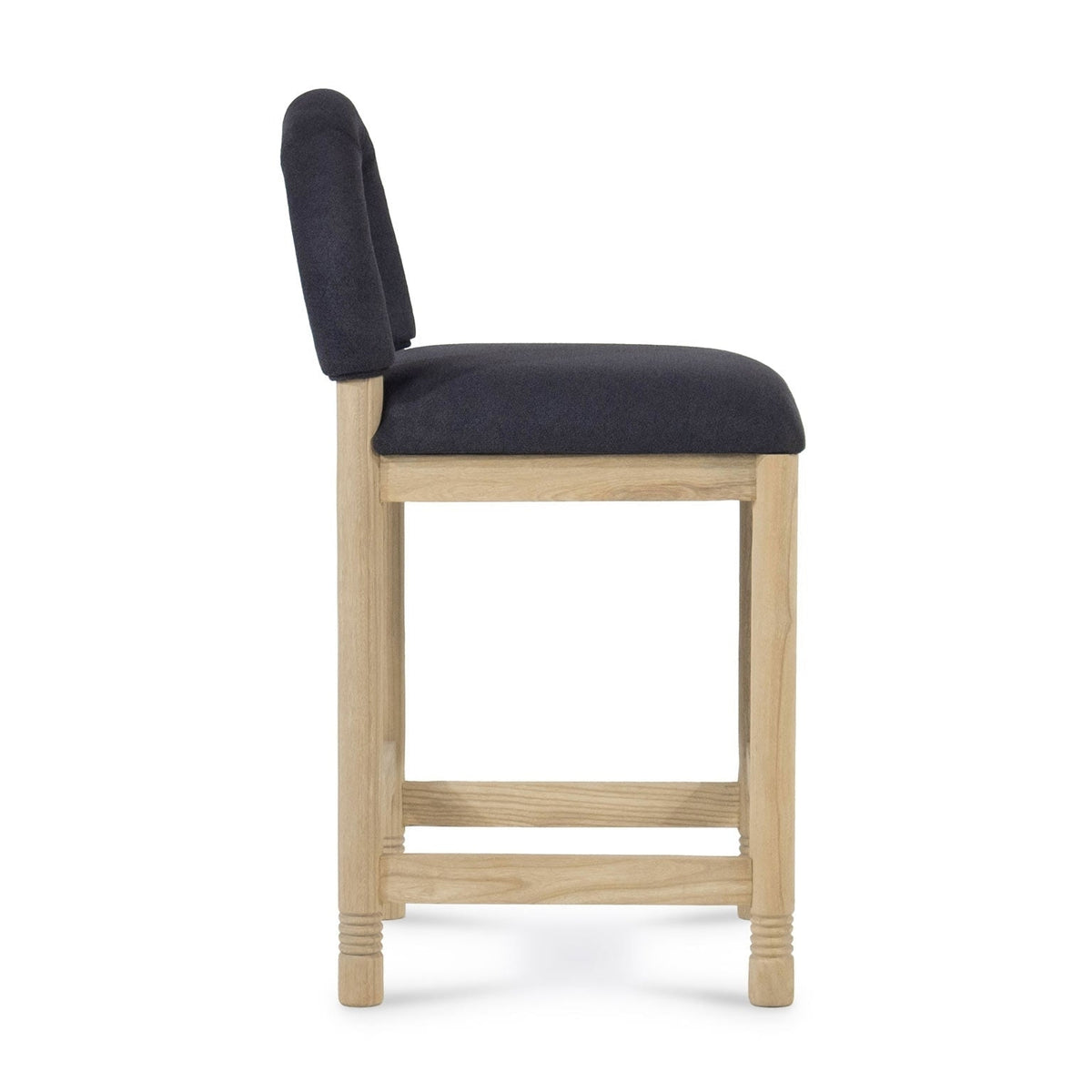 Side profile of a counter stool with a natural oak frame and charcoal bouclé fabric seat and low back, showing square legs, rectangular stretchers and subtle turned detailing at the feet.