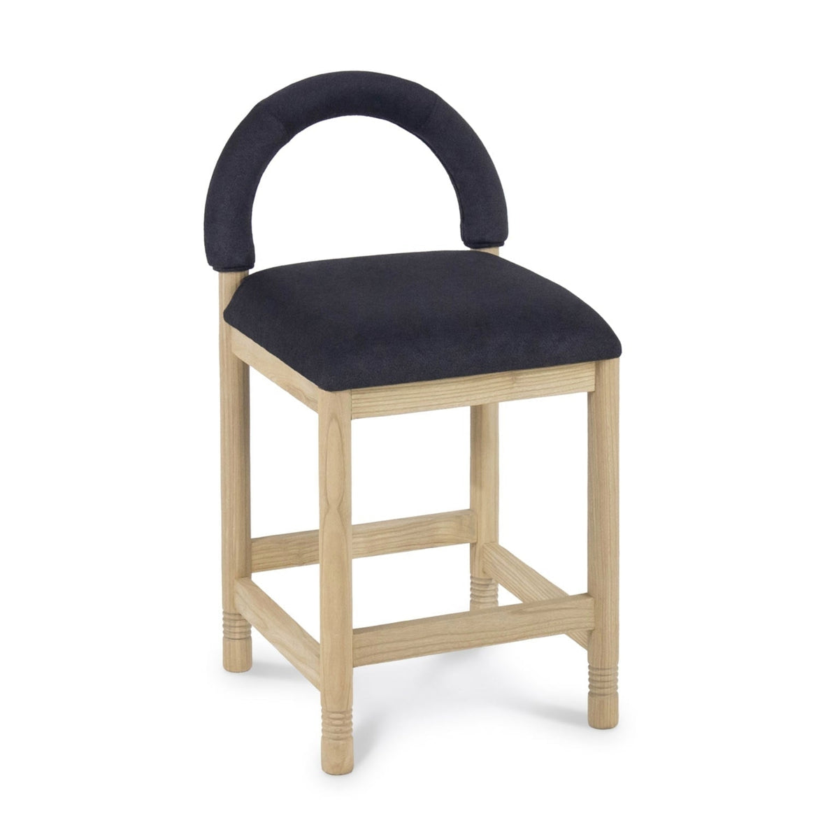 Natural oak-framed stool with a cushioned charcoal boucle seat and low semicircular upholstered back, squared legs with subtle turned detailing and a box stretcher base on a white background.