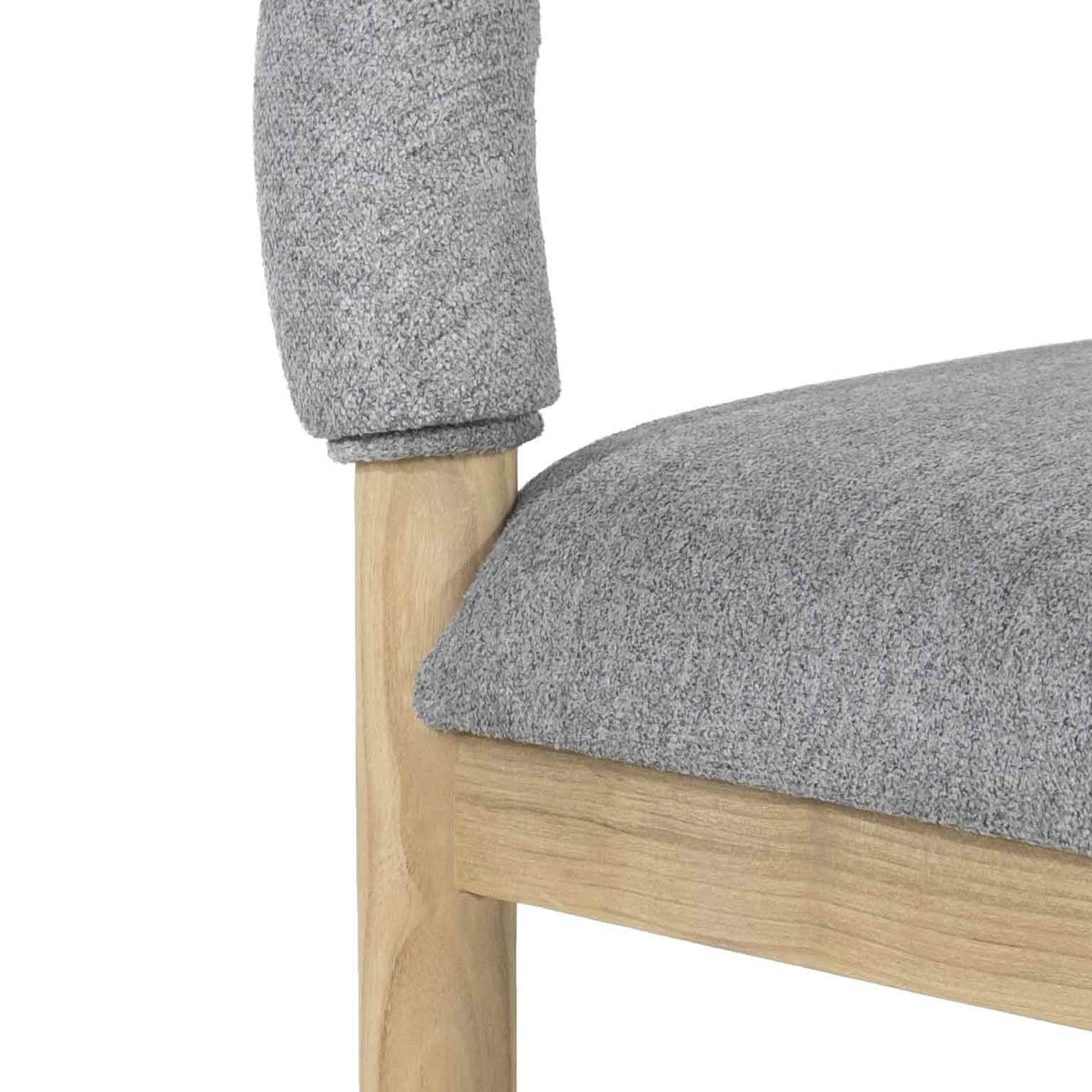 Close-up of a natural oak leg and frame with a light gray boucle fabric seat and padded backrest.
