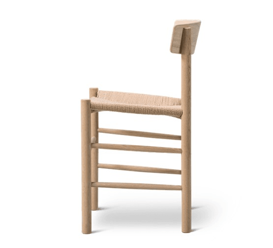 Side view of a Danish mid-century modern dining chair in natural oak with a woven rope seat, low rectangular backrest, rounded legs and multiple horizontal stretcher bars.