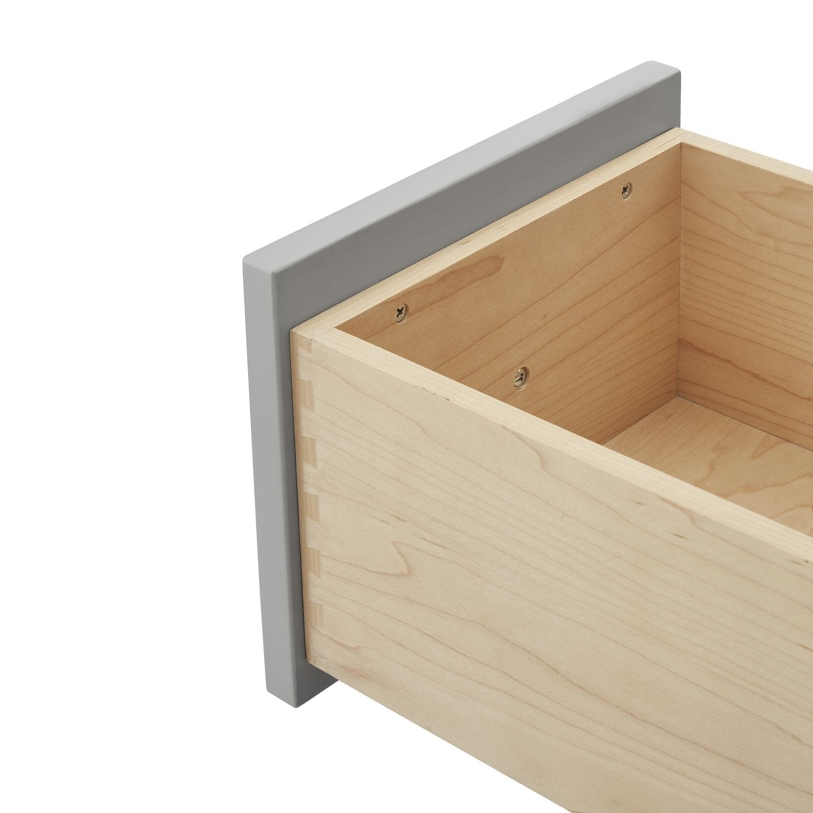 Close-up of a stone-colored vanity face with a natural solid wood drawer box, showing dovetail joinery, interior screws and light wood grain.