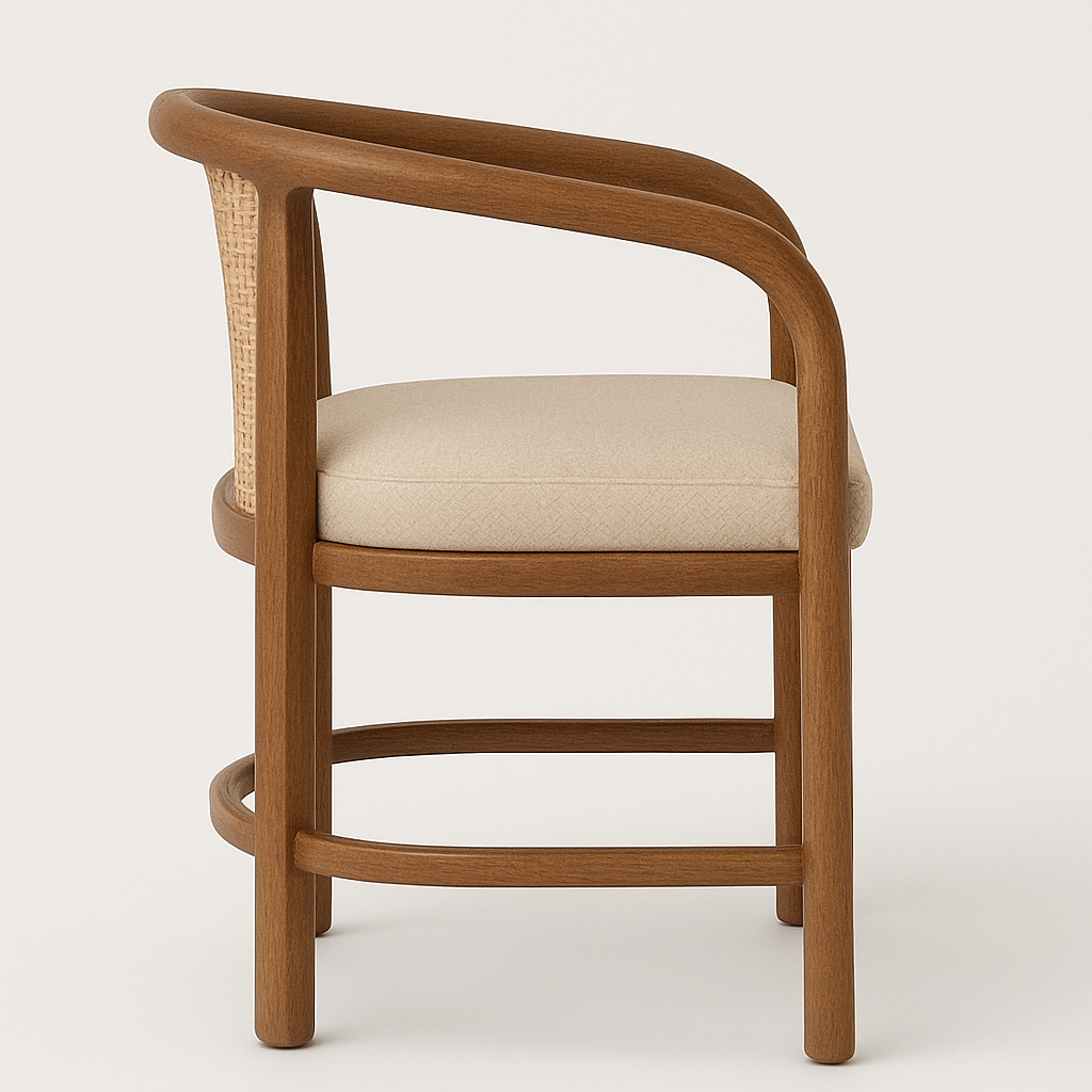 Side view of an outdoor dining chair with a curved teak frame, woven natural rattan back panel and a beige fabric seat cushion, rounded armrest and low curved stretcher supports.