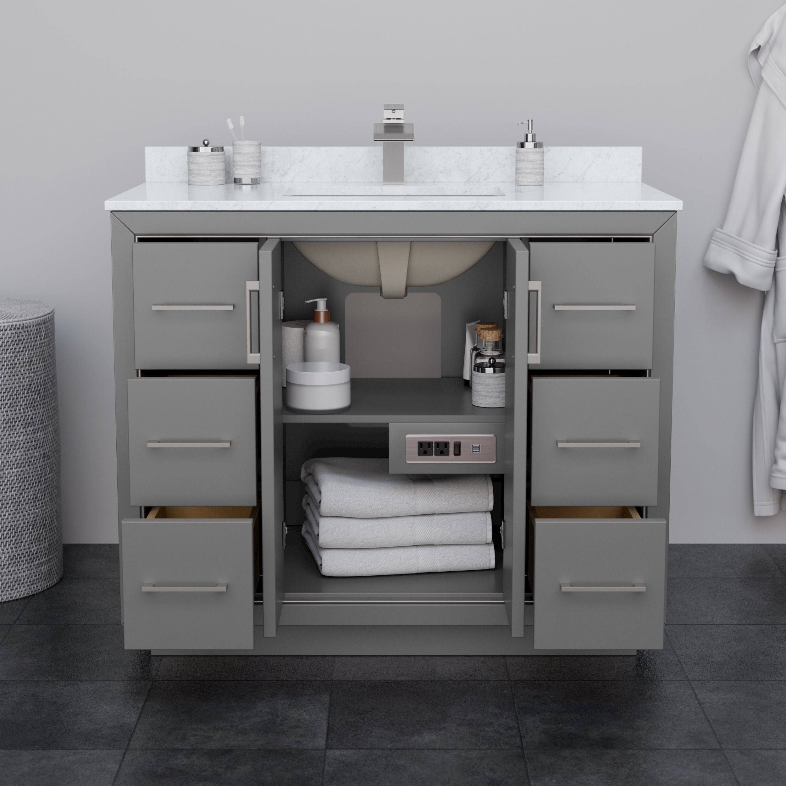 Modern 42-inch solid wood bathroom vanity in stone-gray finish with white stone countertop and integrated rectangular sink, six drawers and open center cabinet showing folded towels, toiletries and a built-in power outlet.