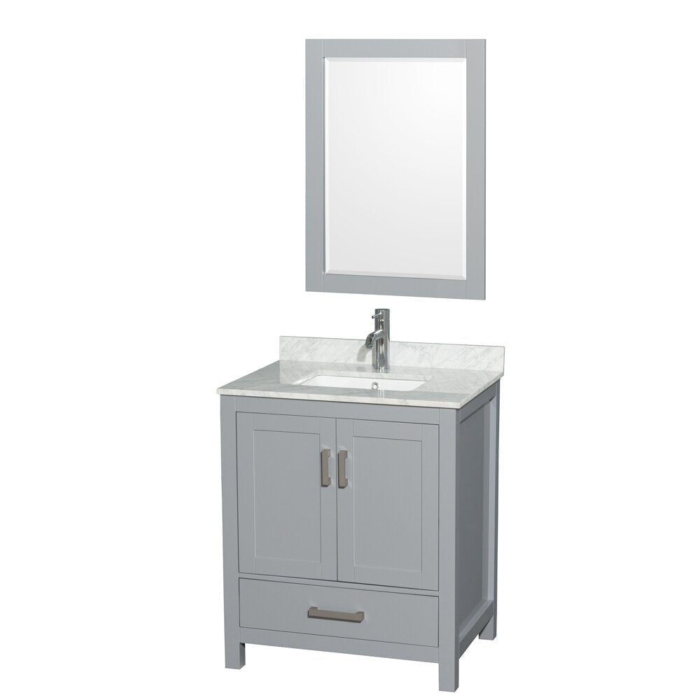 Contemporary gray wooden bathroom vanity with a stone marble top, white undermount ceramic sink, chrome single-handle faucet, two-door cabinet and lower drawer, freestanding and shown with a matching framed mirror.