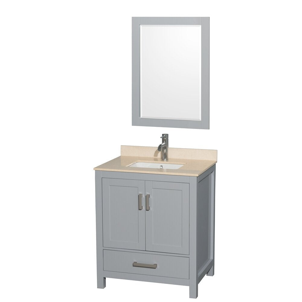 Freestanding modern bathroom vanity in gray solid wood with a beige stone countertop, integrated white ceramic sink, single-handle chrome faucet, two shaker-style cabinet doors, bottom drawer and matching rectangular mirror above.
