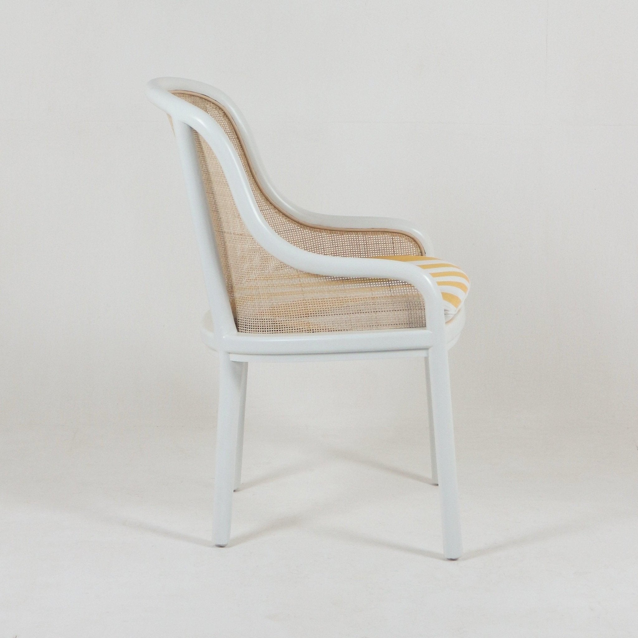 The NUEMA Landmark Bentwood & Cane Dining Chair features caned sides, a curved back and legs, and a yellow and white striped seat cushion. This vintage-style chair is shown in profile against a plain white background.
