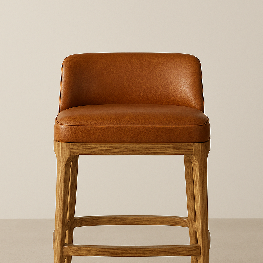 Front-facing contemporary counter-height bar stool with cognac leather upholstered low back and cushioned seat on natural oak legs and integrated footrest, shown against a neutral backdrop.