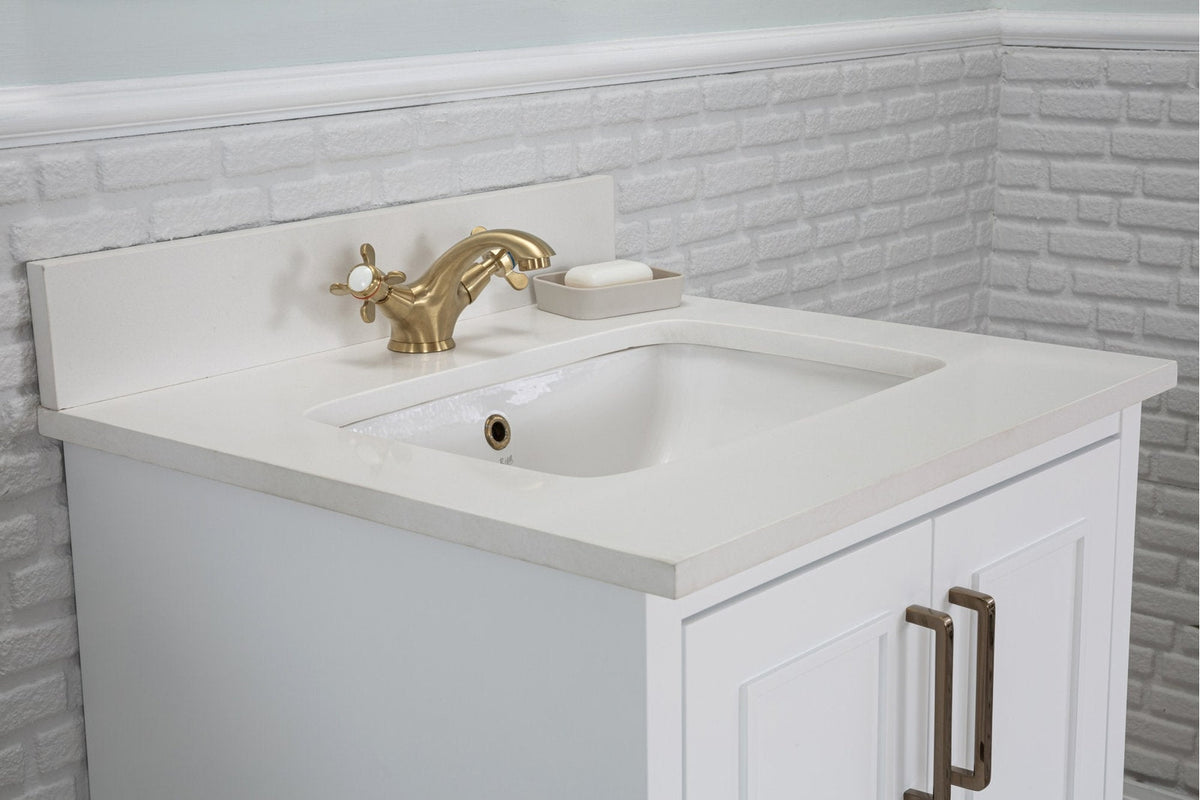 Modern solid wood bathroom vanity with a stone top and integrated white ceramic sink, paired with a brass two-handle faucet, small soap dish, and white paneled cabinet with bronze handles.