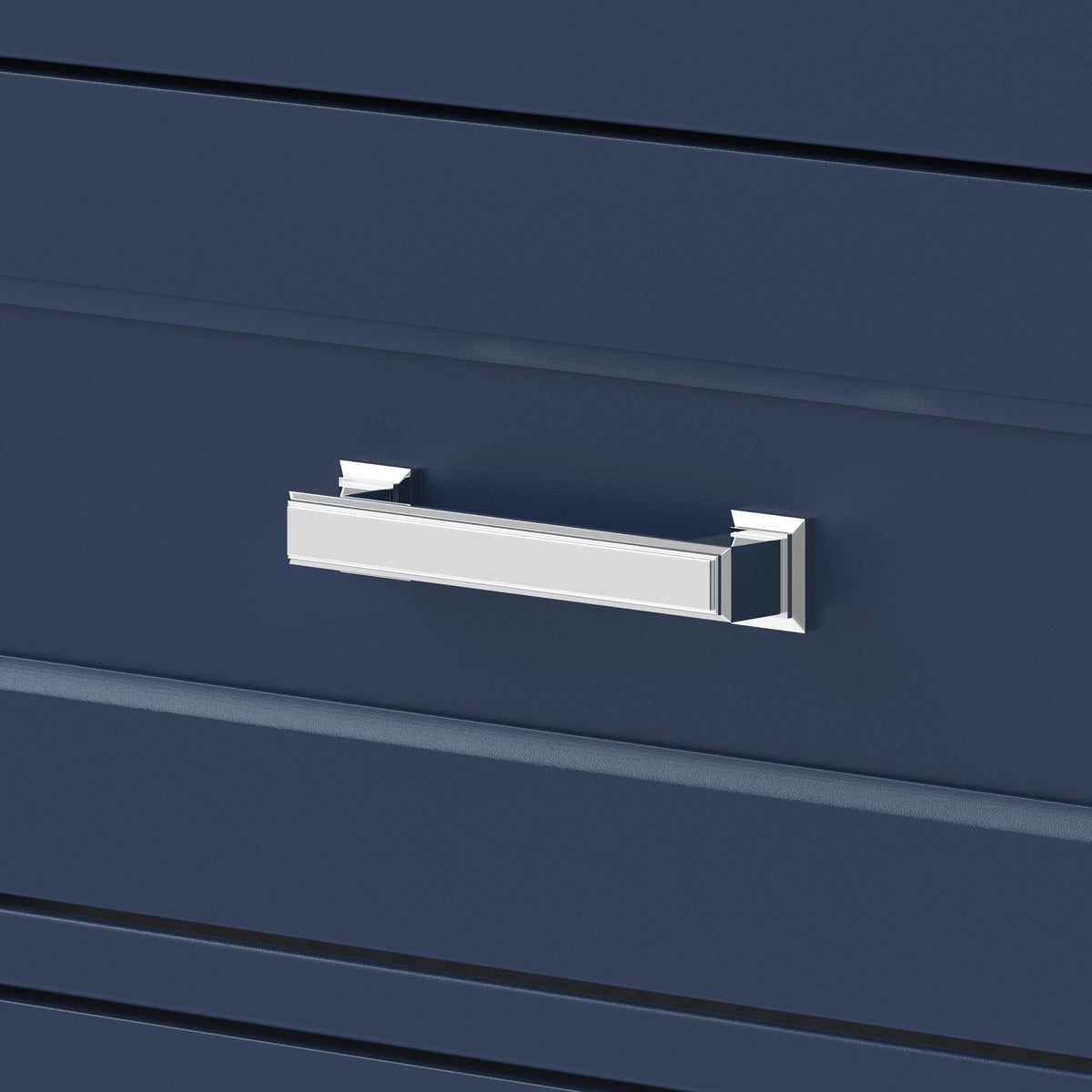 Close-up of a polished chrome rectangular drawer pull mounted on a deep navy wood vanity drawer front, showing beveled edge details and contemporary glam styling.