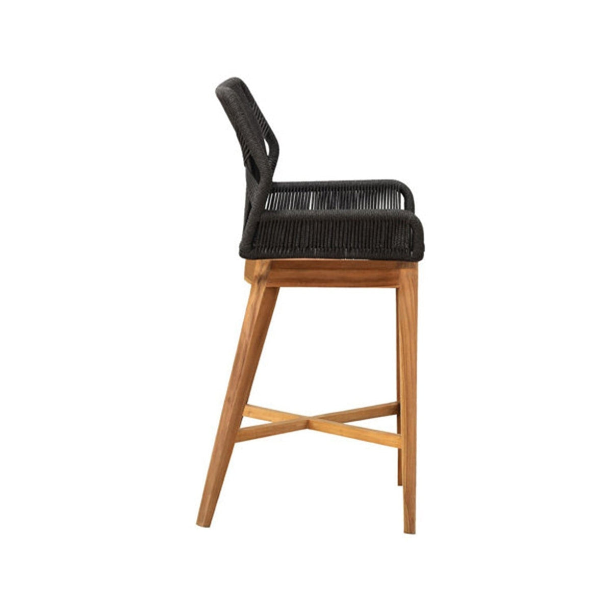 Side profile of a teak outdoor bar stool with natural teak legs and crossed stretcher, black woven rope seat and back with integrated armrests, coastal contemporary style for outdoor or kitchen counters.