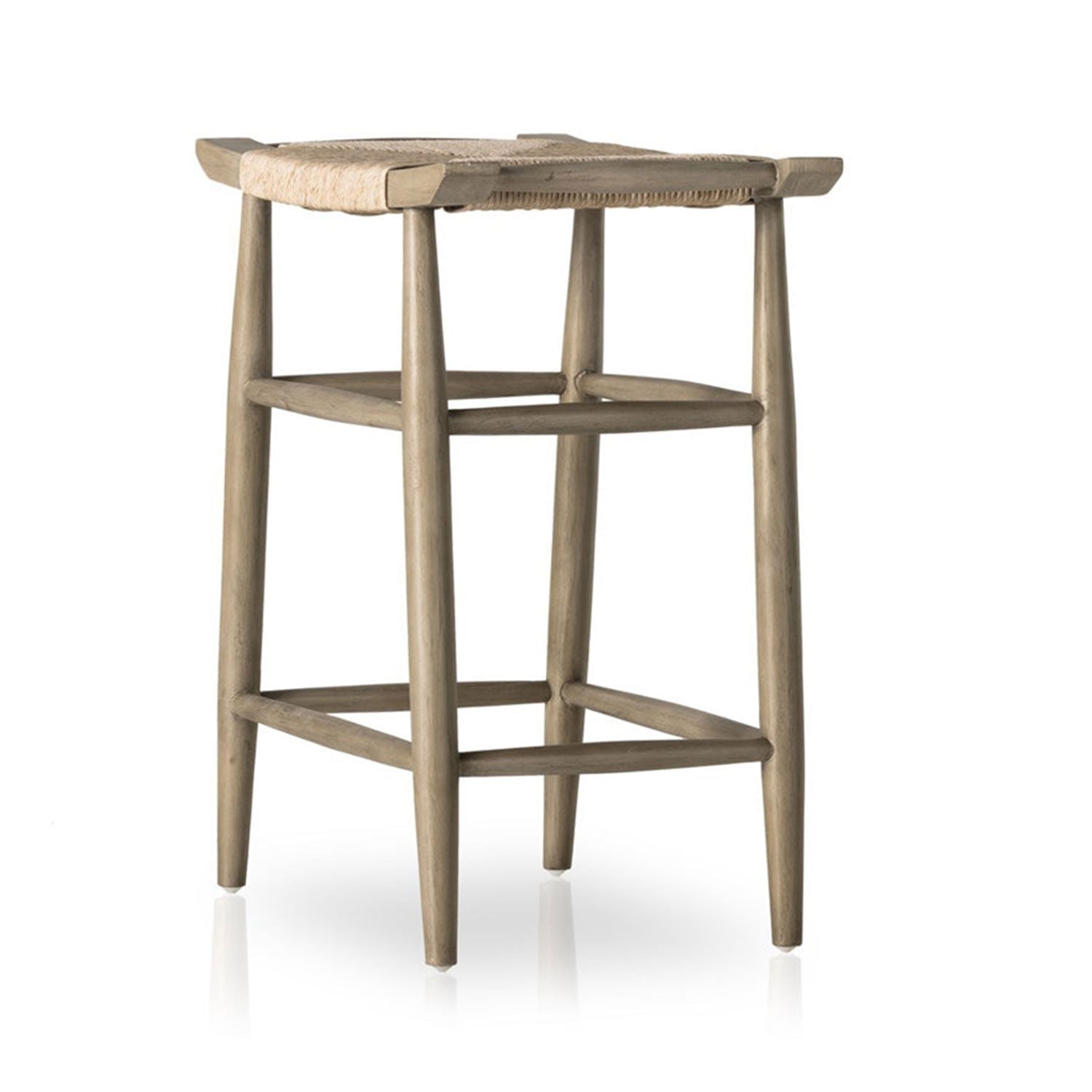 Backless outdoor bar stool in natural teak with woven seat, tapered Scandinavian-style legs and integrated footrest; coastal, armless design shown on a white background.