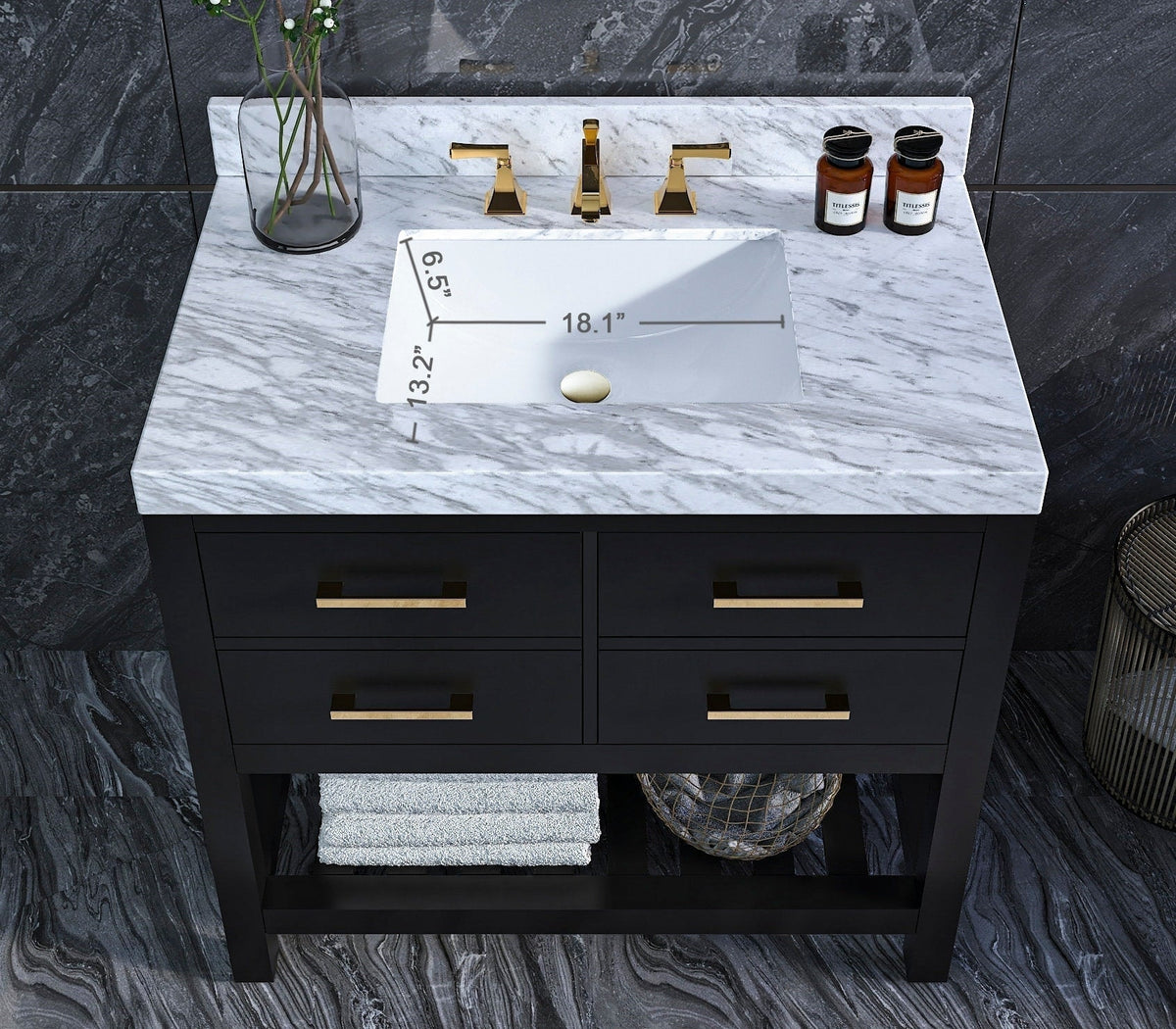 Top-down view of a 36-inch modern solid wood black vanity with stone marble top, white rectangular undermount ceramic sink, brass faucet and drawer pulls, four drawers and an open lower shelf with towels and basket.