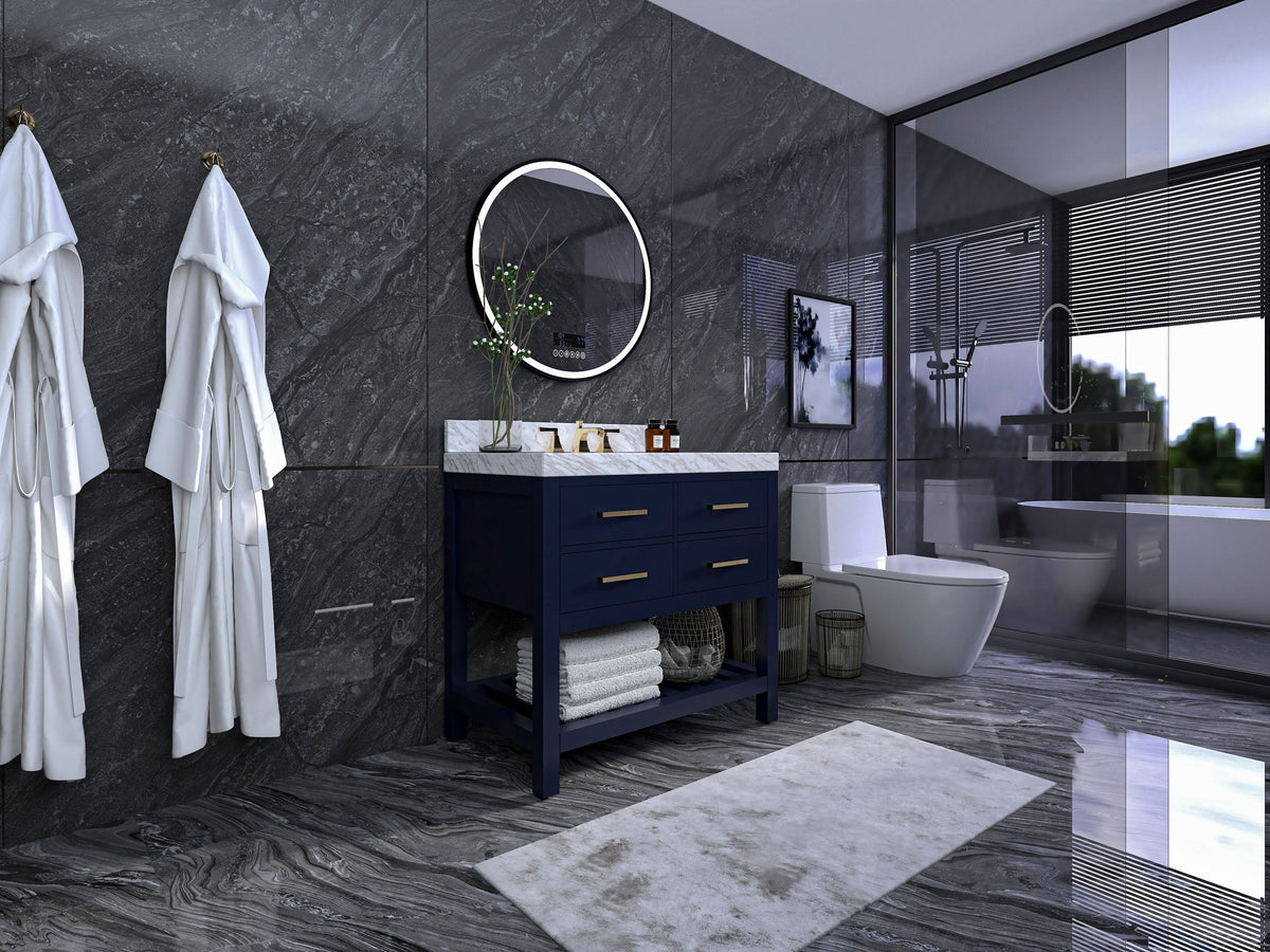 36-inch freestanding solid wood single-sink vanity in deep navy with a stone marble top, gold-tone hardware and open lower shelf with folded towels, set against dark gray marble walls.