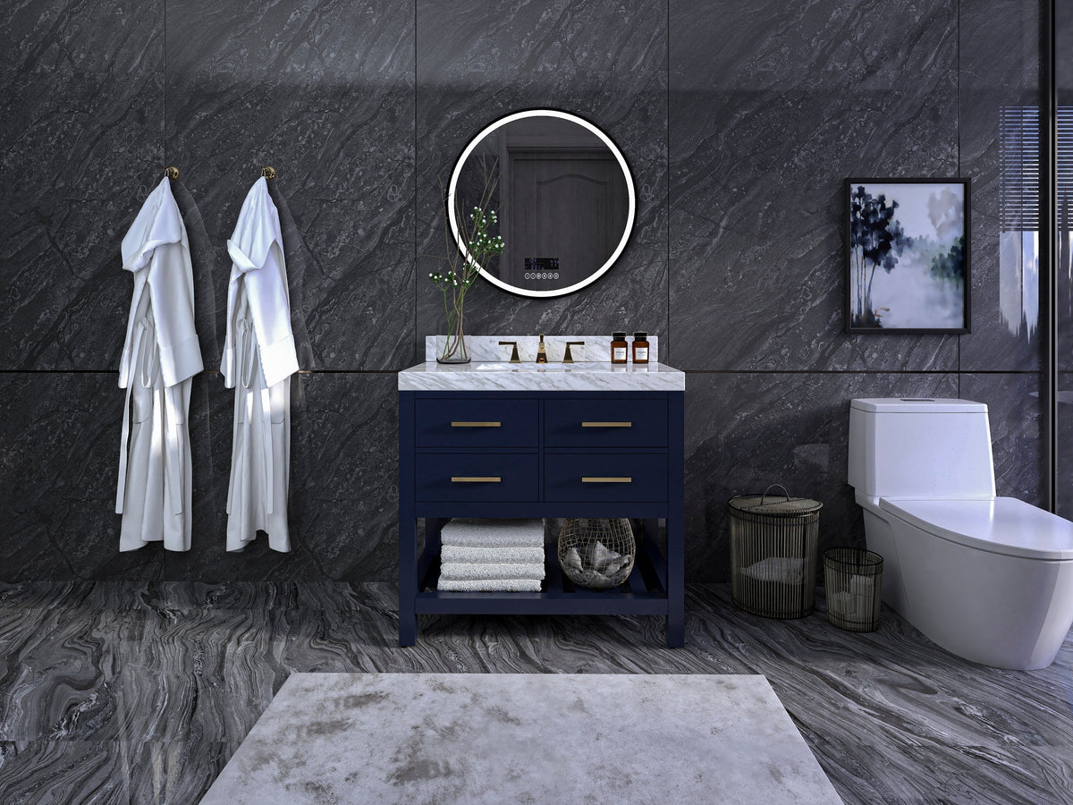 36-inch modern solid wood single-sink vanity with a stone marble top and navy-blue painted base, brass drawer pulls, round LED mirror, ceramic sink and open shelf with folded towels against dark gray stone walls.