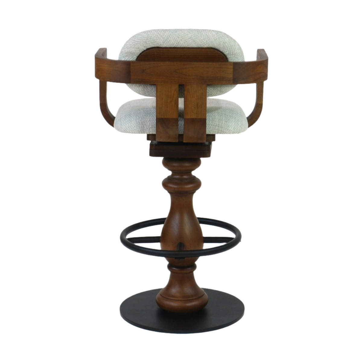 Contemporary swivel bar stool with light gray fabric seat and back, natural walnut-toned wooden curved frame and turned pedestal base, finished with a black metal circular footrest.