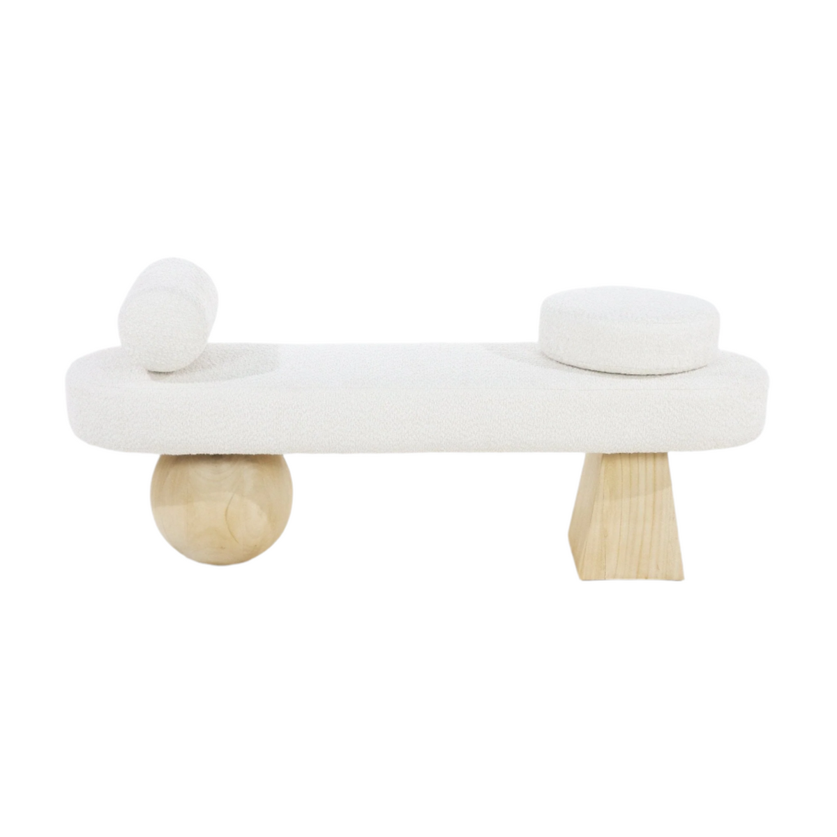 White boucle upholstered end-of-bed bench with a cylindrical bolster pillow on the left and a round cushion on the right, supported by sculptural natural wood legs — one spherical and one tapered.