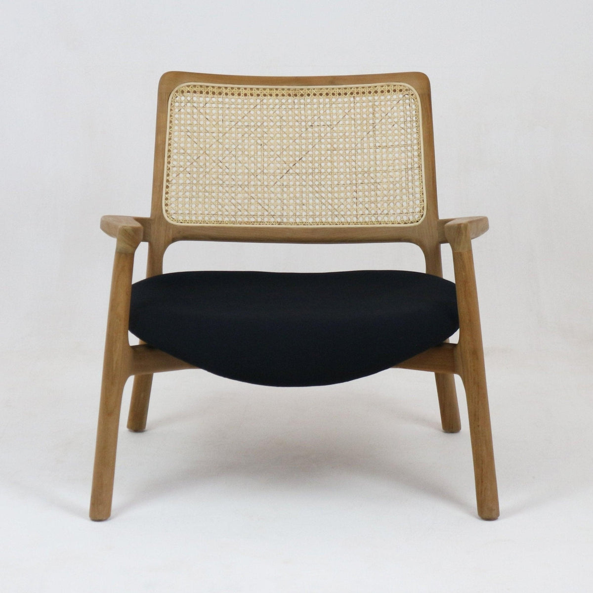 Mid-century modern lounge chair with a teak wood frame, woven cane backrest, slim wooden arms and a low black fabric upholstered seat shown front-facing on a plain white background.