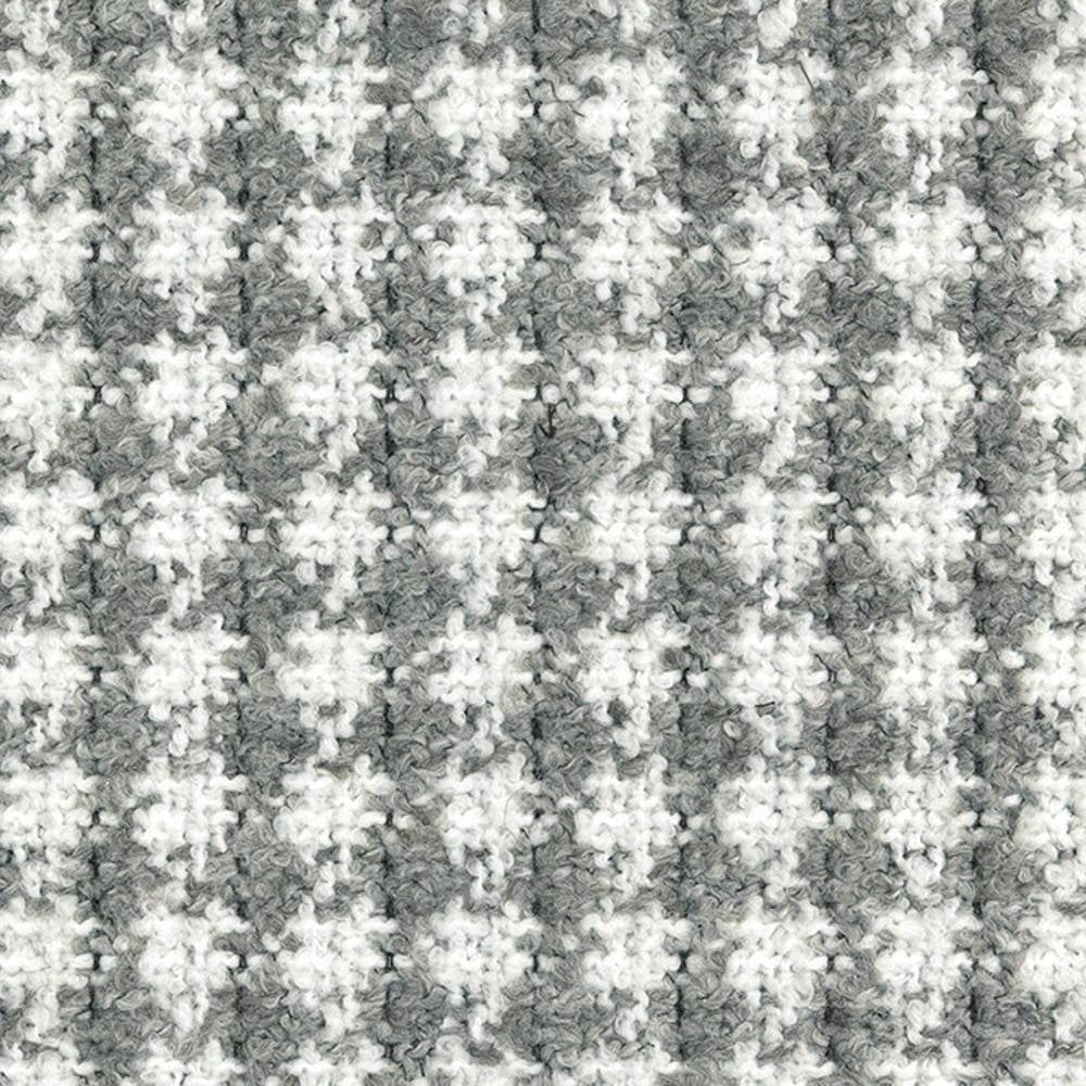 Close-up of gray and white boucle upholstery fabric with a small-scale houndstooth check, showing looped texture and soft pile; 70% acrylic, 30% polyester ideal for contemporary sofa upholstery.
