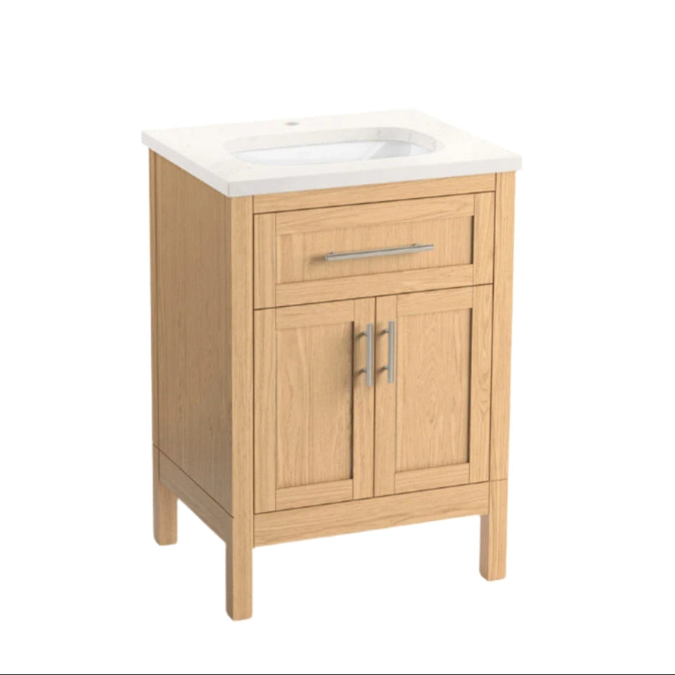 24-inch freestanding natural wood bathroom vanity with a stone-colored quartz top and integrated white ceramic basin, shaker-style drawer and double-door cabinet on square legs with brushed metal bar handles.
