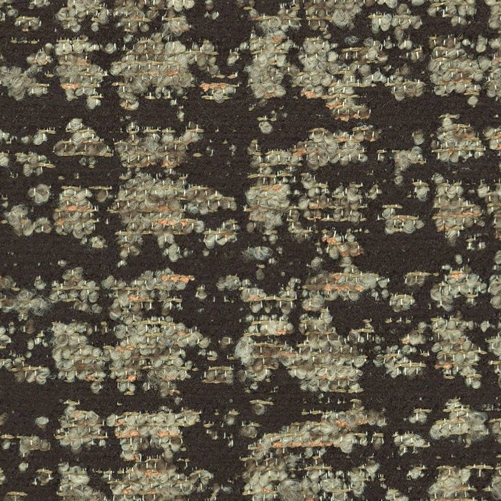 Close-up of dark woven upholstery fabric with beige and cream looped yarns and subtle orange flecks; textured contemporary fabric composed of 41% viscose, 9% acrylic and 50% polyester for sofa use.