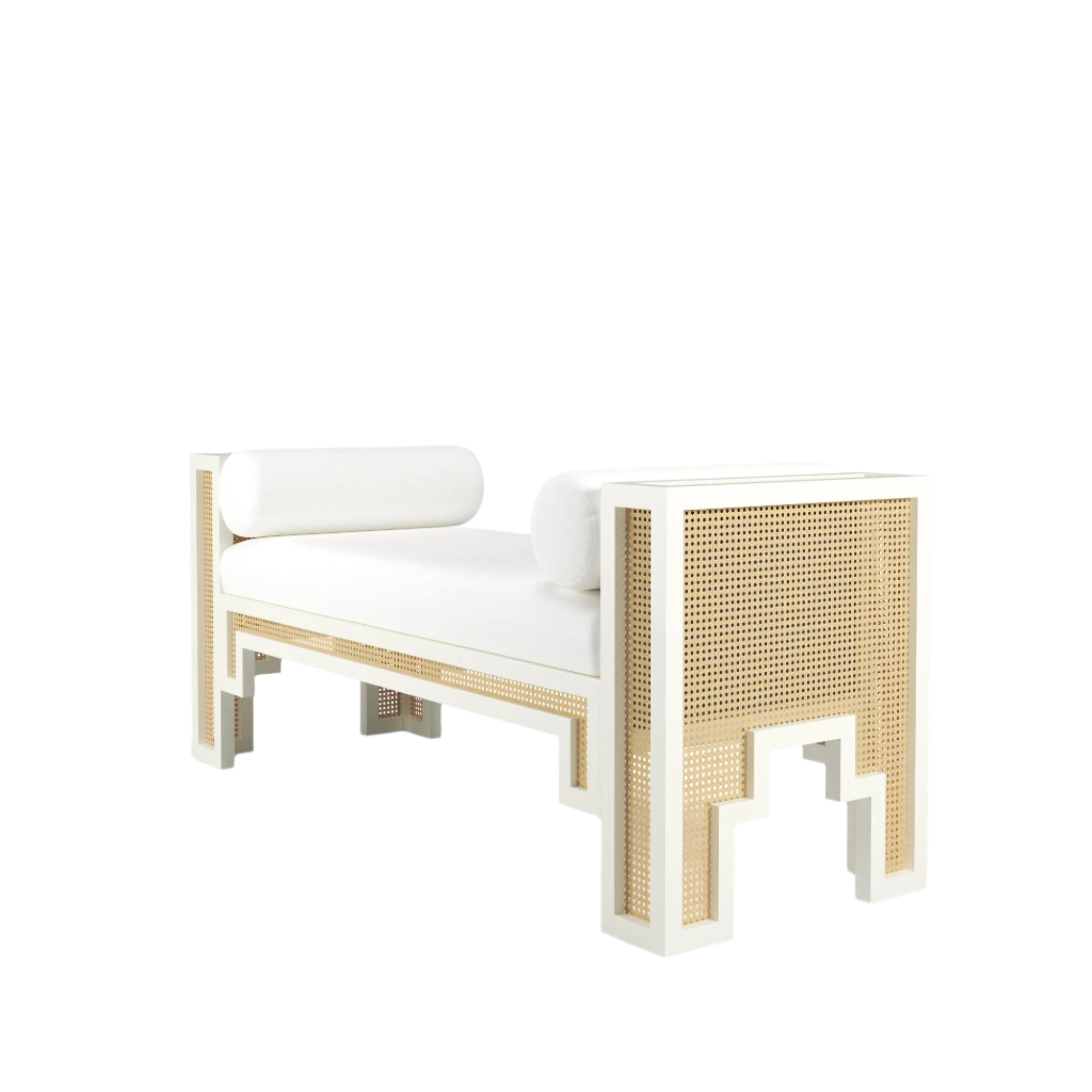 White upholstered 75-inch end-of-bed bench with natural rattan cane panels set into a white painted wood frame, geometric cutout legs and two cylindrical white bolster pillows for a boho-Scandinavian look.