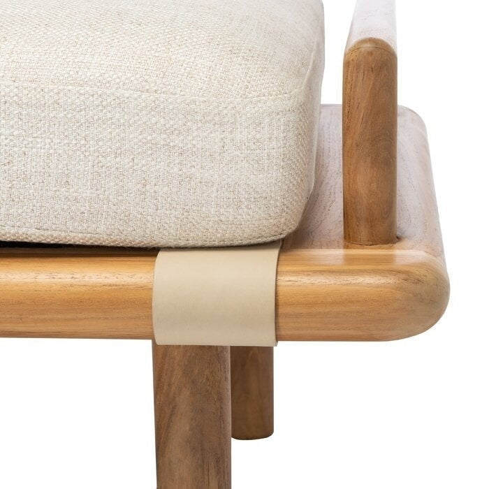 Close-up of a beige boucle upholstered cushion on a rounded light wood bench frame, featuring a beige leather strap and tapered wooden leg in a neutral coastal-contemporary style.