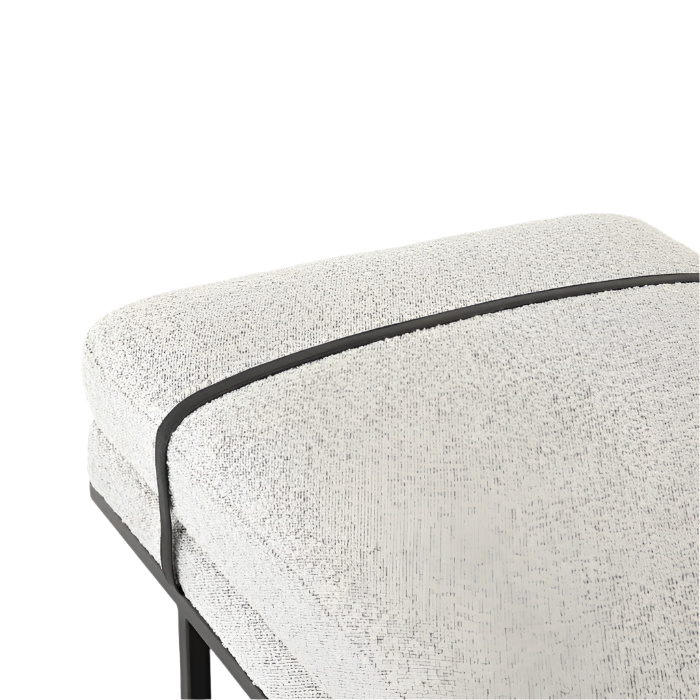 Close-up of a natural ivory boucle upholstered bench seat showing textured boucle fabric, black contrast piping, and dark-finished legs and frame.