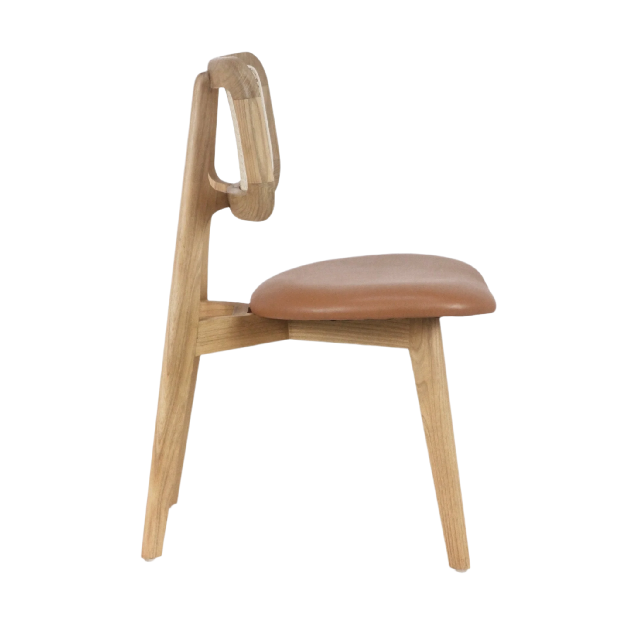 The NUEMA Abode Dining Chair features a modern minimalist design with a curved rattan backrest, padded tan leather seat, and solid wood frame with angled legs, shown side view against a plain white background.