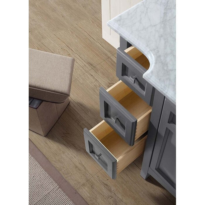 Overhead view of a modern gray bathroom vanity with a marble stone top and three open solid wood drawers featuring recessed panel fronts and square metal pulls on a wood floor.
