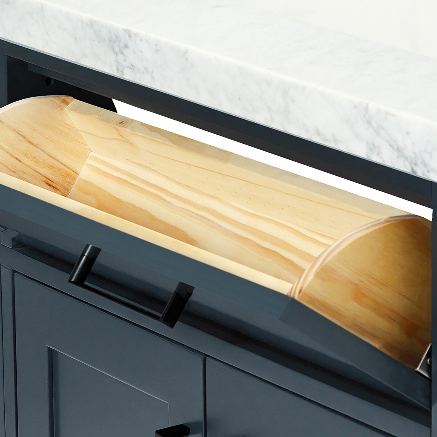Close-up of a modern bathroom vanity showing a white stone countertop, dark stone-colored painted solid wood cabinet with black pull, and a light natural wood tilt-out drawer/bin interior.