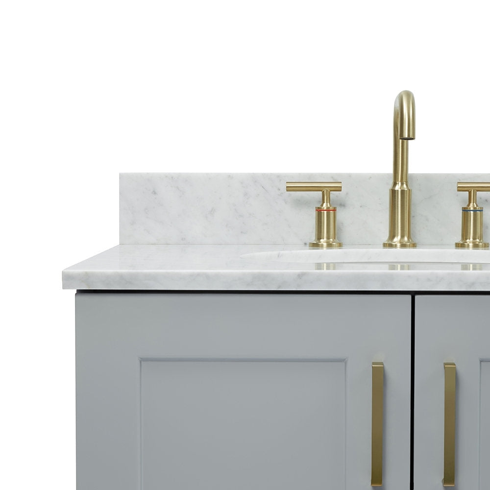 Close-up of a gray solid-wood bathroom vanity with a white stone countertop and backsplash, undermount sink, and satin bronze curved faucet with T-handle valves and matching vertical bronze cabinet pulls.