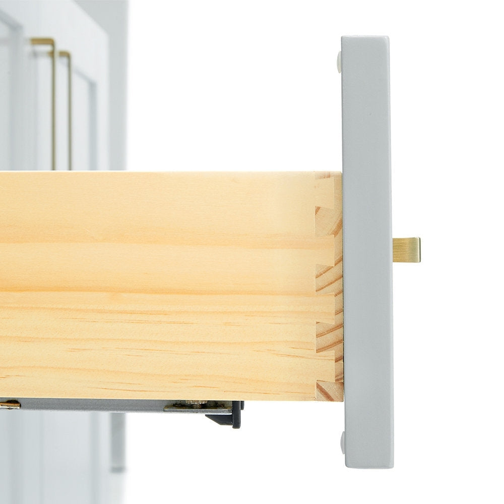 Close-up of a solid wood vanity drawer showing dovetail joinery, light natural wood interior, gray painted drawer front, satin bronze pull and visible metal slide hardware from a modern bathroom vanity.