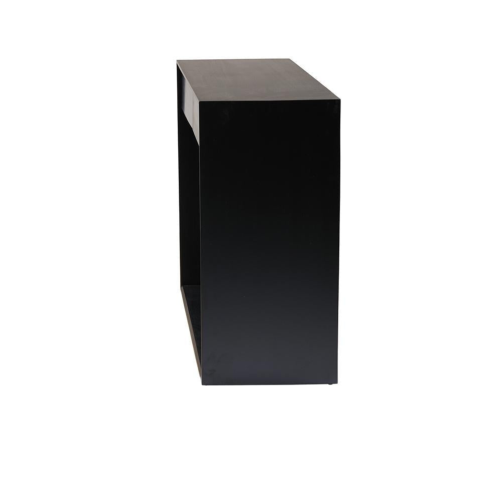 Side view of a modern black mahogany console table showing its rectangular minimalist form and open lower shelf against a white background.