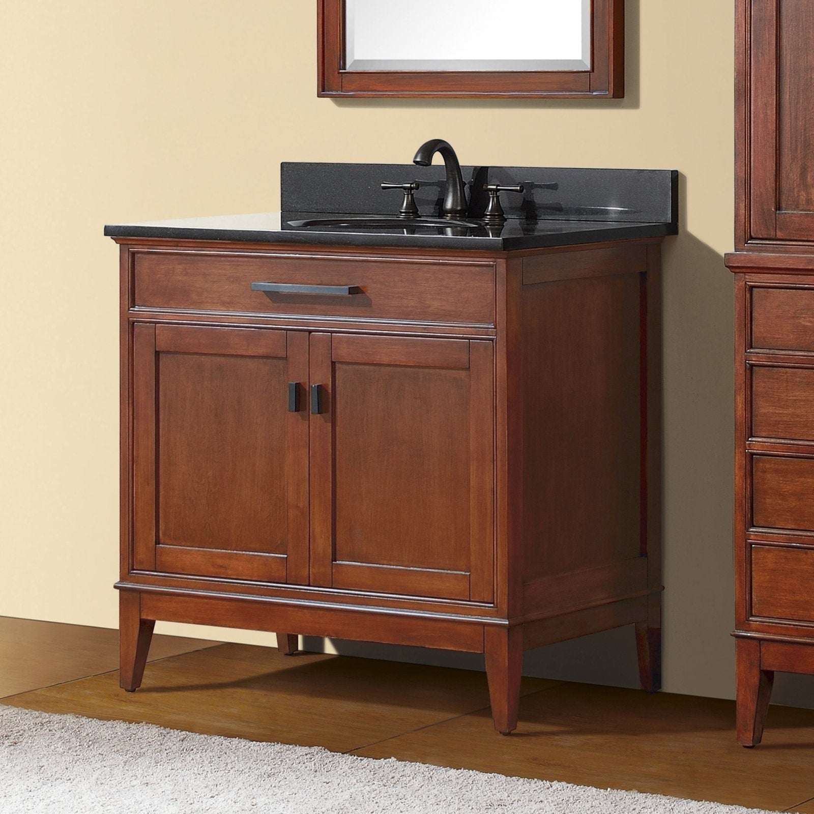 Freestanding 37-inch modern solid wood bathroom vanity in warm brown finish with a dark stone countertop and backsplash, single undermount sink with black faucet, one drawer and two-door cabinet on tapered legs.